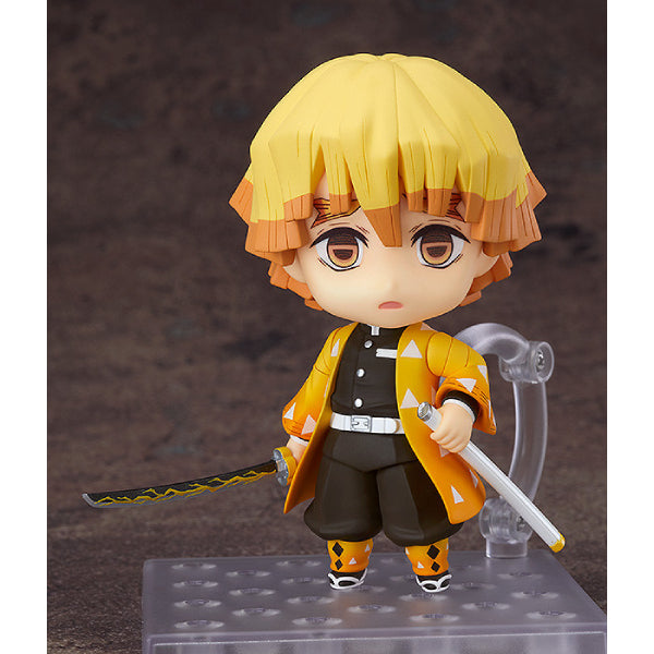 A Nendoroid figure of Zenitsu Agatsuma from Demon Slayer, featuring a chibi-style design, with yellow hair and a black and orange outfit. The figure is displayed with a stand, holding a Nichirin Blade and a Thunder Breathing action pose.